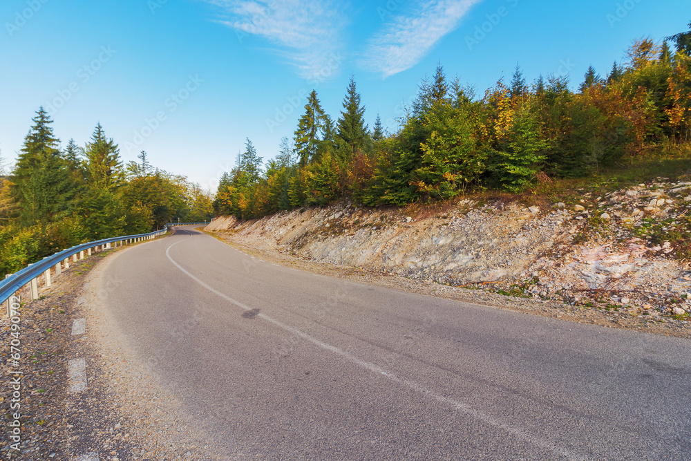 Fototapeta premium road through forested hill of apuseni natural park, romania. autumnal mountainous landscape in morning light