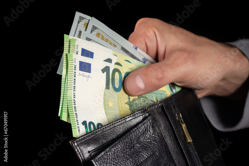 Cash of 100 dollar and 100 euro note, in wallet. Lot of one hundred dollar bills close-up. dollars in wallet