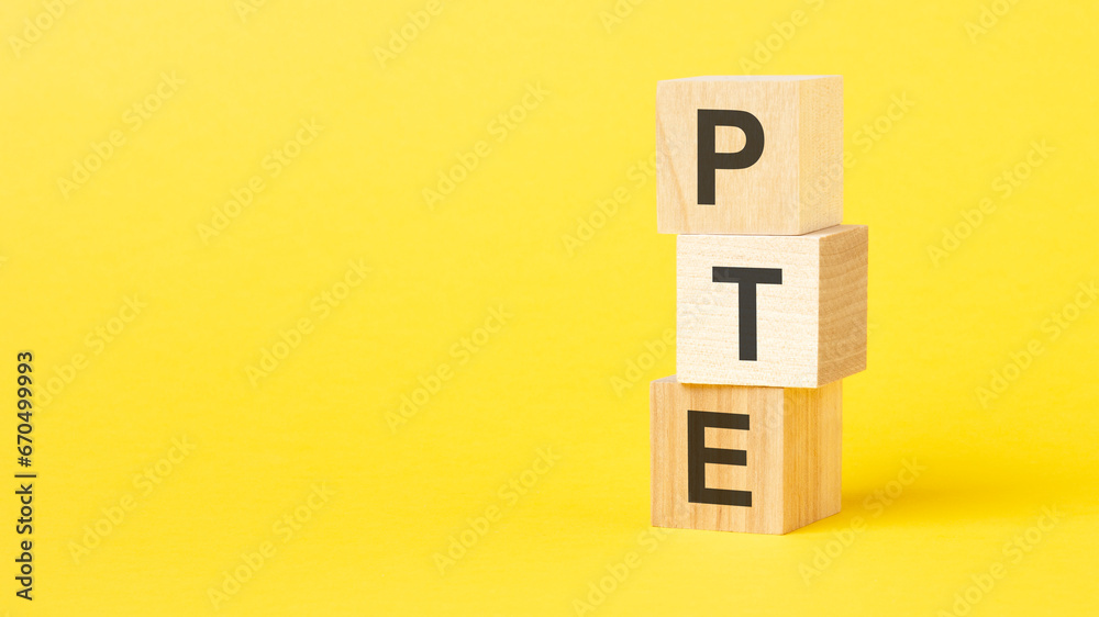 wooden blocks with the text PTE - short for Pearson Tests of English on a bright yellow background wooden blocks with the text PTE - short for Pearson Tests of English on a bright yellow background