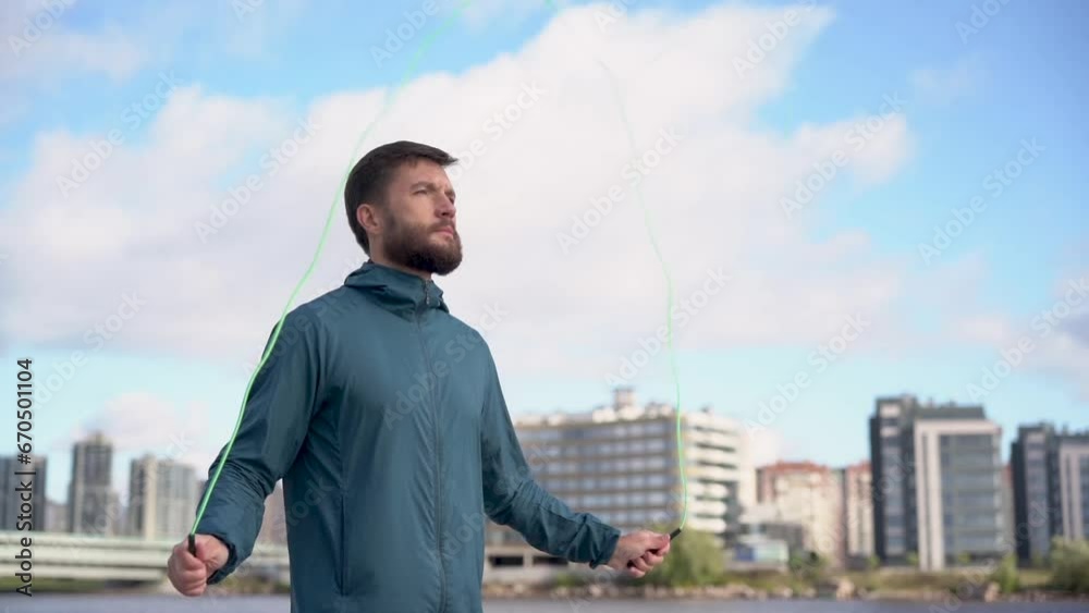 Jumps uses a jump rope athlete, motivation sports day in the morning cardio training. Athlete in sportswear slim workout fitness health lifestyle in the cold.