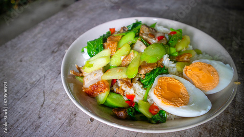 Thai food, kana moo krob.(fried kale mixed crispy pork),Crispy Pork fried with Kale Thai delicious food, closeup, side view