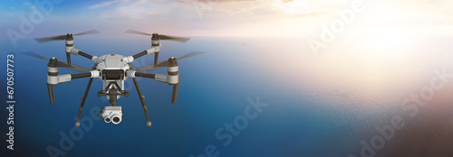 Fototapeta Naklejka Na Ścianę i Meble -  A modern aerial drone (quadcopter) with remote control, flying with an action camera. Flying over the sea. Background: photo. Drone: 3d model. Sunset. 3d illustration.