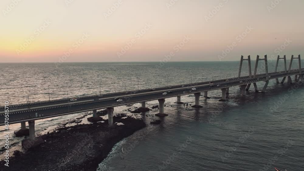 Cinematic aerial view of traffic passing over Bandra Worli Sea Link in Mumbai, India in the evening. Sunset View of the Sea Bridge. bridge over the sea. Cinematic aerial view of traffic passing over Bandra Worli Sea Link in Mumbai, India in the evening. Sunset View of the Sea Bridge. bridge over the sea.