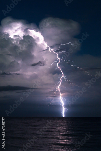 Bright lightning in the night over ocean concept of bad weather and bad weather.