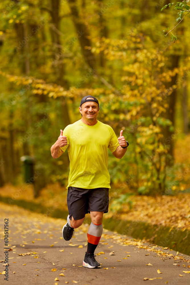 Portrait of a middle-aged man running in the park on an autumn day. Portrait of a middle-aged man running in the park on an autumn day.