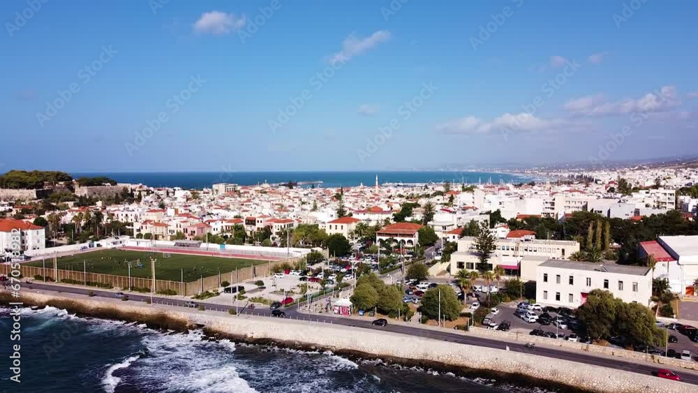 Sea waves rolling towards coast of Rethymno town, aerial view Sea waves rolling towards coast of Rethymno town, aerial view