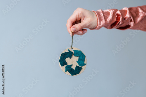 Handmade Christmas decoration in women's hands. Creative symbol of clothing recycling. Ecological and sustainable fashion photo