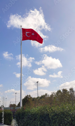 Turkish flag on cloudy blue sky background, sunny day