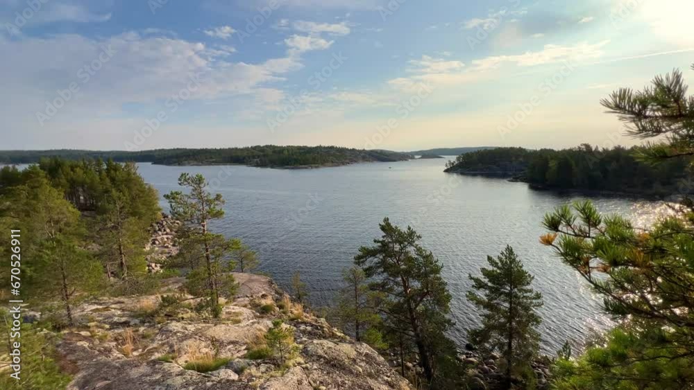 Russia, Karelia, Lake Ladoga, Koyonsaari. View of the coast of the island in a cold lake. Beautiful nature of the Republic of Karelia. Stunning panoramic view of the Ladoga Skerry Islands. 4K Russia, Karelia, Lake Ladoga, Koyonsaari. View of the coast of the island in a cold lake. Beautiful nature of the Republic of Karelia. Stunning panoramic view of the Ladoga Skerry Islands. 4K