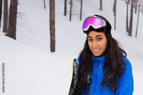 athletic girl with a snowboard and goggles on a high snowy mountain, a girl with long hair rides on the mountain in winter