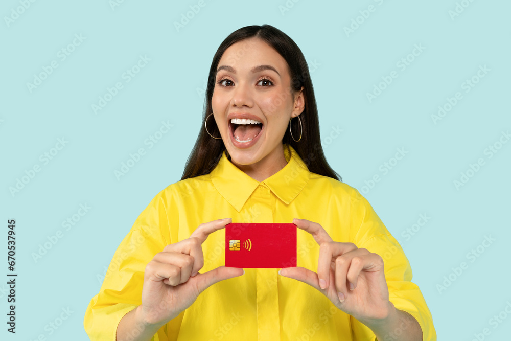 Happy brunette young woman holding credit card Happy brunette young woman holding credit card