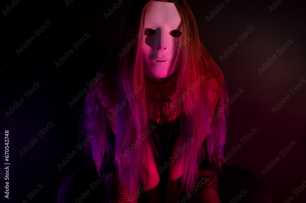 An enigmatic female figure bathed in vivid neon light poses dramatically, her face masked, evoking themes of mystery, nightlife, and modern cyberpunk aesthetics.
