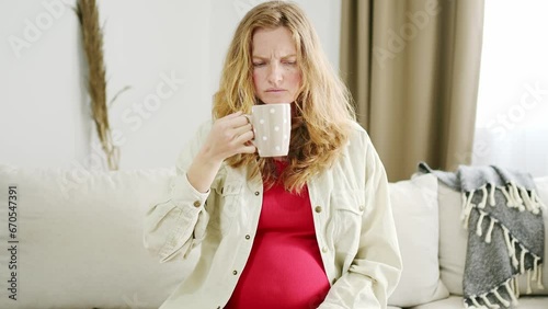 A young pregnant woman suffers from toxicosis. The expectant mother feels nauseous and develops an aversion to the smells of food and drinks. Pregnancy side effects photo