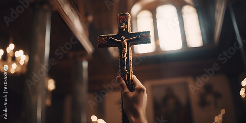 Fototapeta Hand holding a cross in church during prayers, Mass in the Catholic Church,