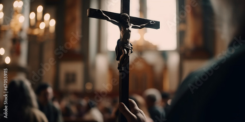 Hand holding a cross in church during prayers, Mass in the Catholic Church,  photo