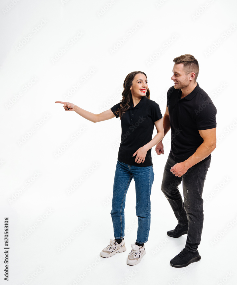 A Couple Gesturing Towards an Unseen Object. A man and a woman pointing at something A Couple Gesturing Towards an Unseen Object. A man and a woman pointing at something