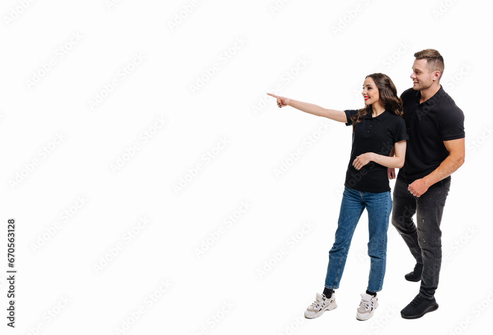 Naklejka premium A Couple Excitedly Pointing Towards an Intriguing Object. A man and a woman pointing at something