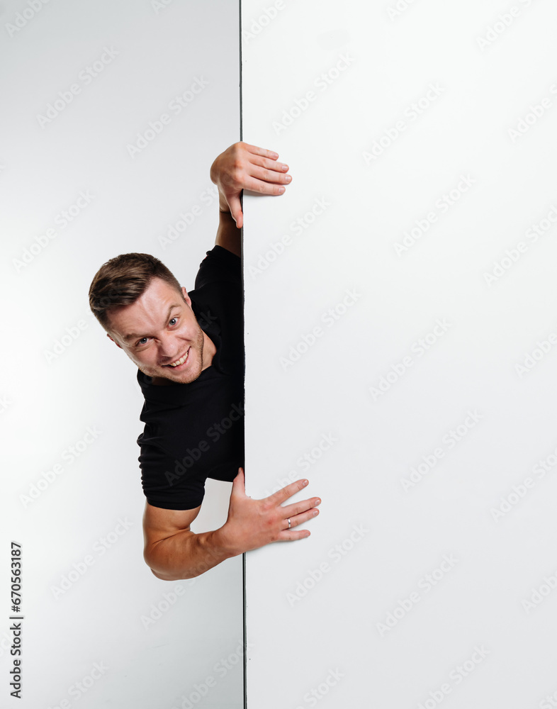 A Man Holding a Whiteboard With Important Information. A man is holding onto a white board