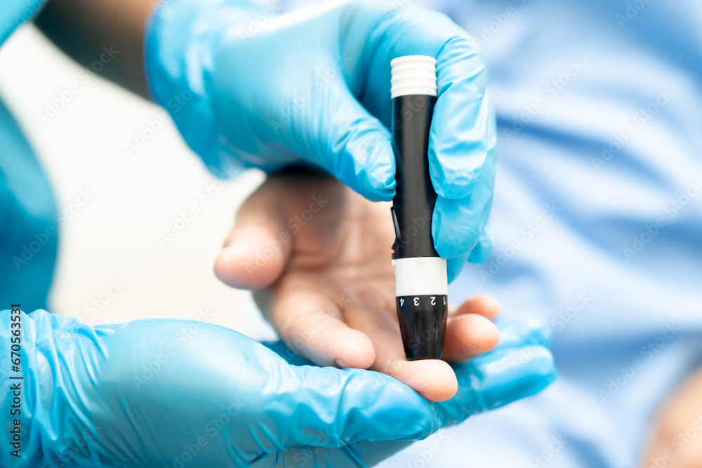 Doctor check diabetes from finger blood sugar level with finger lancet. Doctor check diabetes from finger blood sugar level with finger lancet.