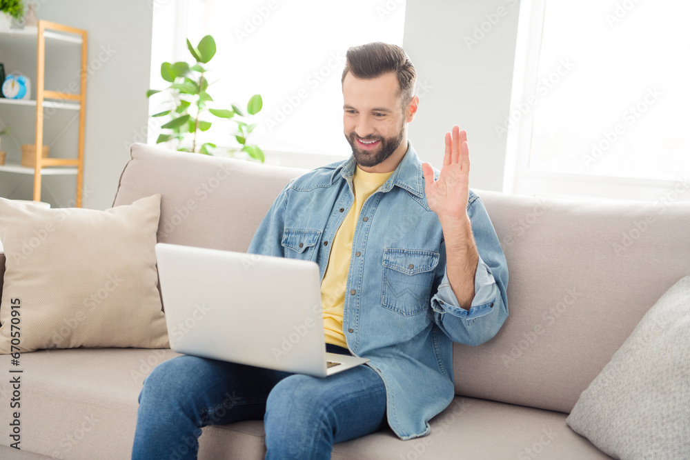 Full length body size photo of student working on laptop talking with web camera waving hand greeting Full length body size photo of student working on laptop talking with web camera waving hand greeting