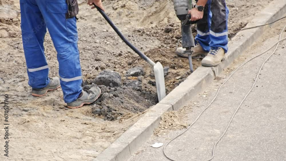 Roadworks Construction Site Conctractor Replacing Concrete Curb Brick using Shovel and Pneumatic Hammer Roadworks Construction Site Conctractor Replacing Concrete Curb Brick using Shovel and Pneumatic Hammer