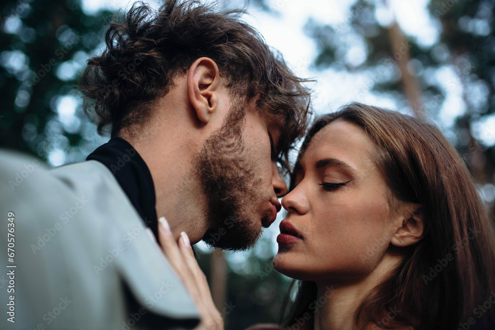 sensual couple in love close-up kissing, curly man and beautiful woman. sensual couple in love close-up kissing, curly man and beautiful woman.