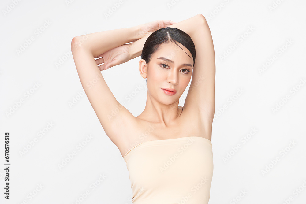 Beautiful Young Asian woman lifting hands up to show off clean and hygienic armpits or underarms on white background, Smooth armpit cleanliness and protection concept Beautiful Young Asian woman lifting hands up to show off clean and hygienic armpits or underarms on white background, Smooth armpit cleanliness and protection concept