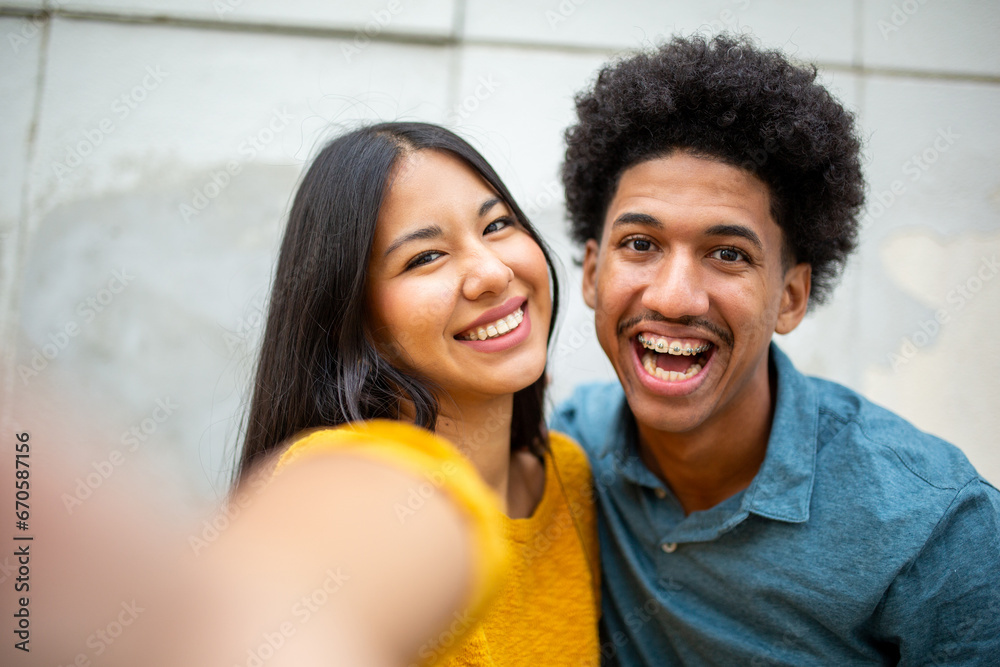 Close up smiling young couple taking selfie together Close up smiling young couple taking selfie together