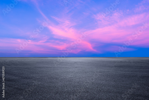 Asphalt road platform and pink sky clouds landscape at sunset