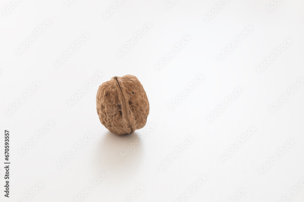 Walnuts on a white table. Pure white background. Walnuts on a white table. Pure white background.