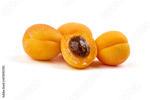 Isolated apricots. Fresh whole apricot fruit with half, isolated on white background.