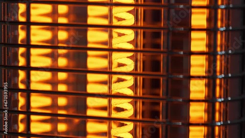 Infrared heater. Heating device with red-hot spiral filament. Energy efficient space heater. Vertical freestanding infrared heater for indoor use