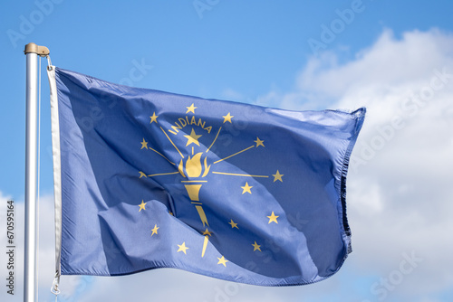 Indiana state flag flying in the wind against blue sky  photo
