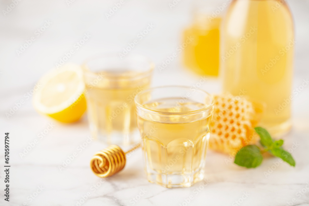 Mead, alcoholic honey strong drink. Alcoholic tincture with honey and lemon Mead, alcoholic honey strong drink. Alcoholic tincture with honey and lemon