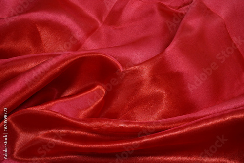 A piece red cloth. Fabric texture and design works of art, beautiful wrinkled pattern of silk or linen.