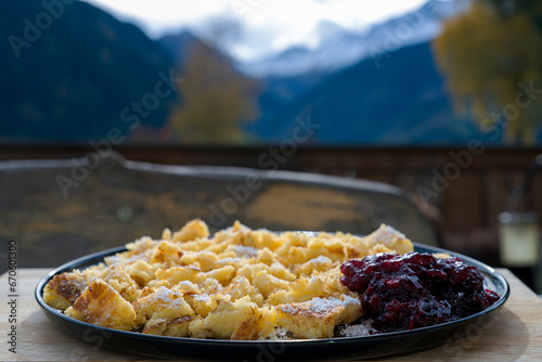 eating on the balcony at a autmn day - semolina omelet dessert with homemade cranberry jam served on a black plate