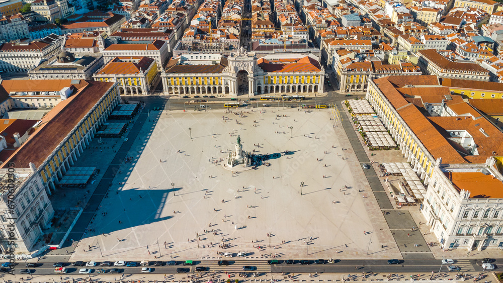 Fototapeta premium Aerial drone point of view of Commercio Square, Downtown Lisbon, Portugal. Panoramic view of cold city center. Travel destination visited annually by many foreigner tourists. Sunset colours