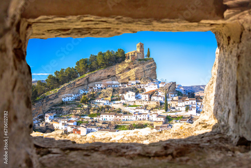 Scenic white village of Montefrio near Granada view through stone window photo