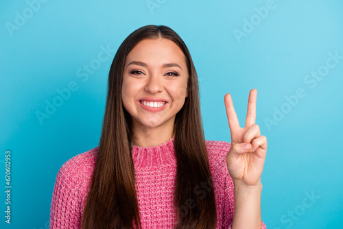 Photo of pretty adorable young lady wear striped sweater showing two v-signs cover eyes isolated blue color background photo