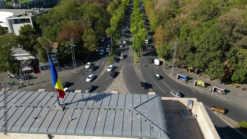 Aerial drone footage of the Free Press Square viewed from the Arcul De Triumf square in the capital of Romania - Bucharest. Kiseleff road seen from the air. Aerial video. Flag of Romania
 photo