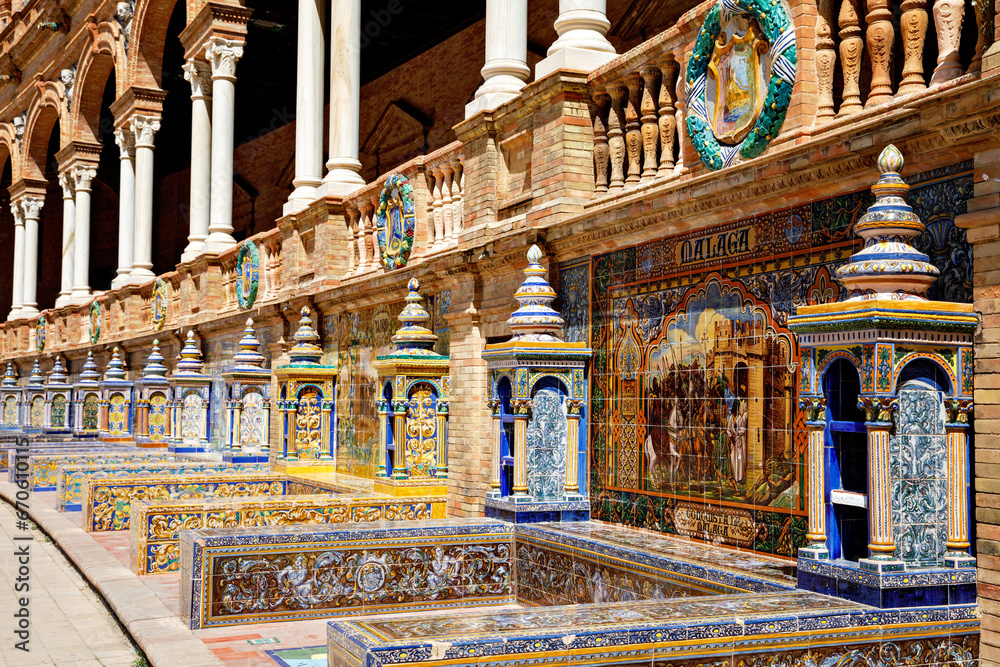 Fototapeta premium SEVILLE, SPAIN - 13 APRIL, 2023: The tiled Provincial Alcoves along the walls of the Plaza de Espana in Seville, a big tourist centre in Spain