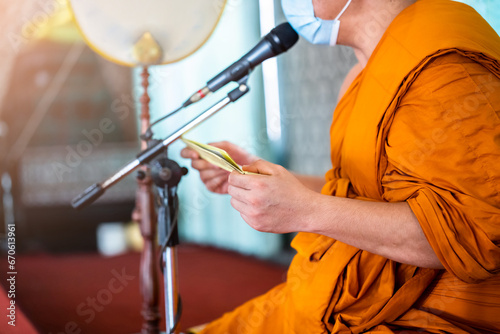 A monk is reading scriptures to teach Buddhists. Buddhist training ceremony. photo
