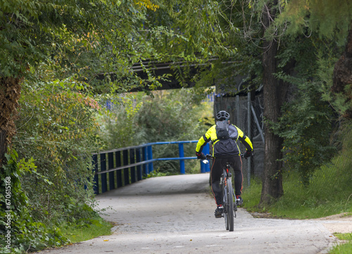 Male race cyclist driving on the road photo