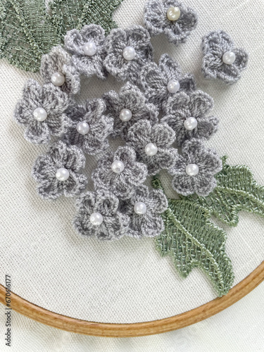 Fototapeta Naklejka Na Ścianę i Meble -  white linen fabric with embroidery hoop frame and grey crochet floral flower