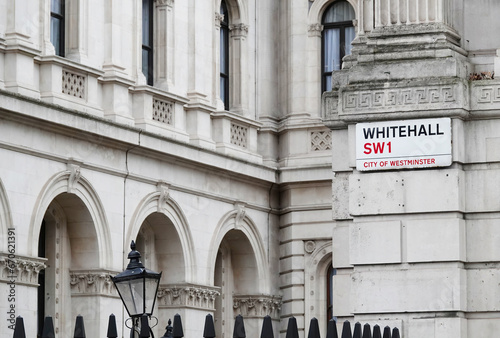 Whitehall sign on the wall of a government building at the entrance to Downing Street in Westminster, London SW1, UK.  photo