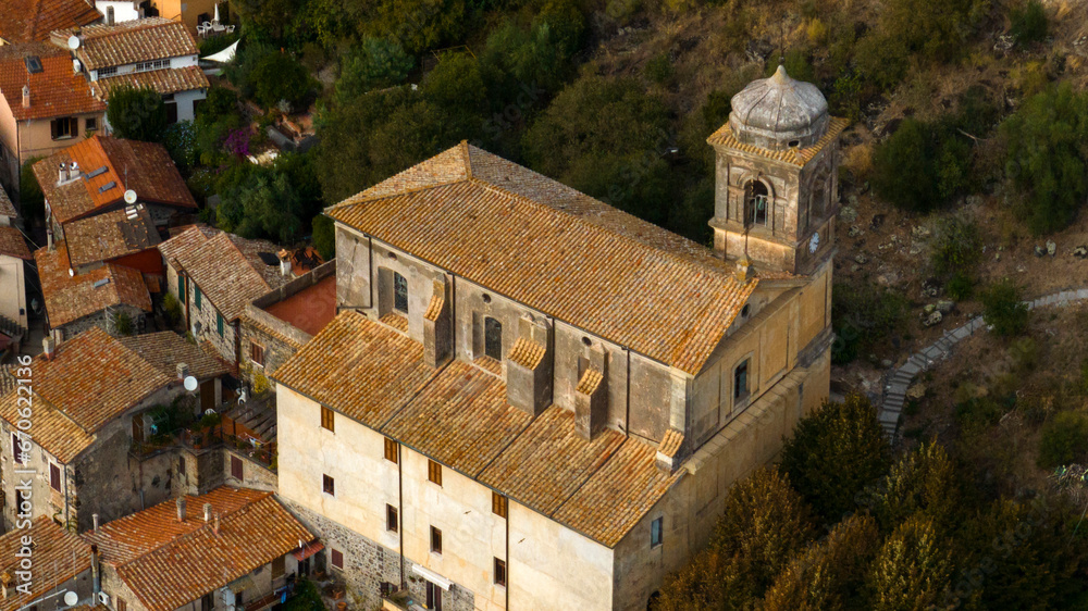 Aerial view of the church of Santa Maria Assunta located in the center of the historic village of Trevignano Romano, in the metropolitan city of Rome, Lazio, Italy.