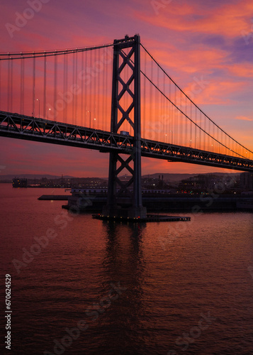 Fototapeta Naklejka Na Ścianę i Meble -  SF Bay Bridge During Vibrant Red Sunset