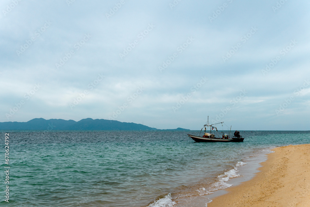 Fishing boat near the shore with blue sky as the background