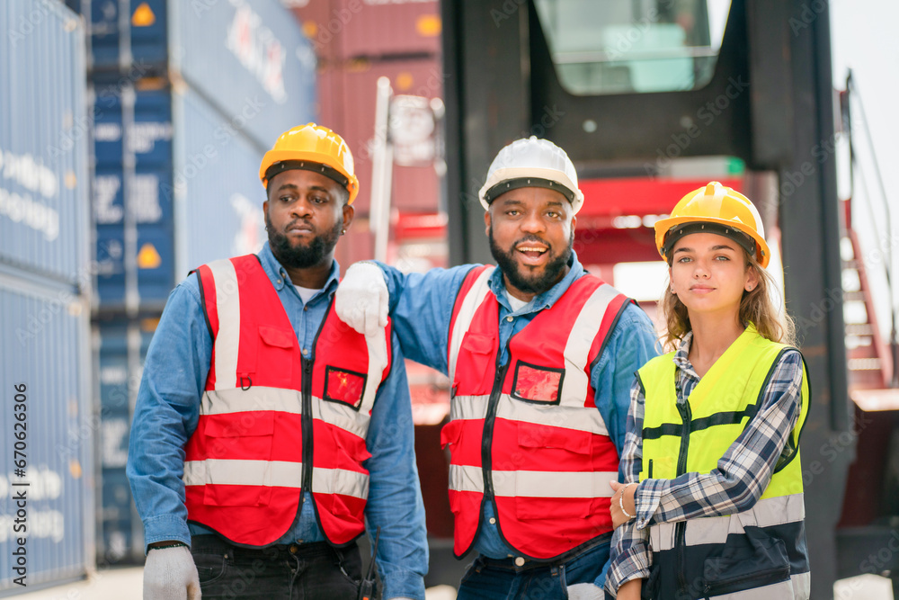 Portrait of Engineer or foreman team pointing up the future  with cargo container background at sunset. Logistics global import or export shipping industrial concept.