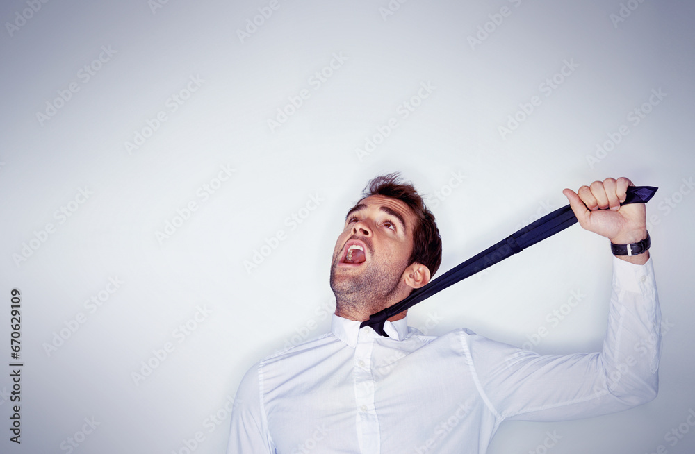 Stress, mental health and a man choking on his tie in studio on a white ...